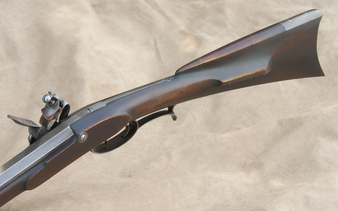 Jim Kibler contemporary styled carved rifle with bold finishing
